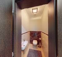 Toilet with a sink in a 4-room apartment, ceramic tiles, dark wood.