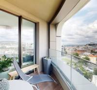 A view of Bratislava from a private terrace in a 3-room apartment, with comfortable seating.