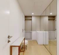 An entrance hall with a wooden decor floor and large mirrors in a 3-room apartment.