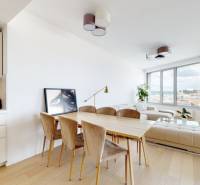 A bright living room with a dining table, a white sofa, and a view, 3-room apartment.