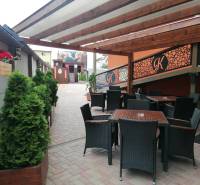 Outside in Poprad, hotels and guesthouses, terrace with rattan furniture and decorations.