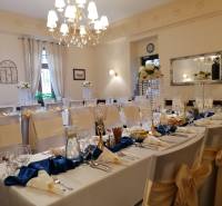 Wedding decoration in the interior of the hotel restaurant, elegantly set tables with floral arrangements.