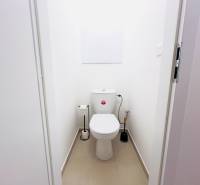 A bathroom with white walls in a two-room apartment, simple sanitary equipment.