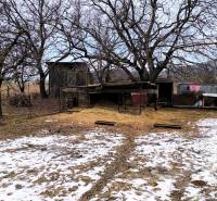 Snow-covered residential plots with trees on Mierová Street in Krásnohorské Podhradie.