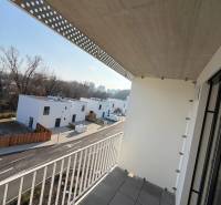 The balcony of a studio apartment on Agátová Street in Bratislava - Dúbravka with a view of modern houses.