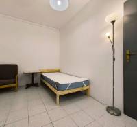 Single room with an armchair and a floor lamp in a family house.