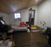 One room in a family house with an exercise bike and a wooden decor floor.