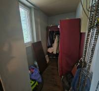Storage space in a family house with a wooden decor floor and a lot of items.