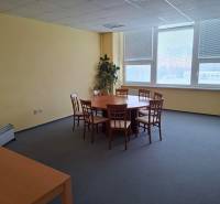 Meeting room with a round table and chairs in the office.