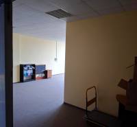 Offices with dark carpet, shelves, and boxes, suitable for rent.