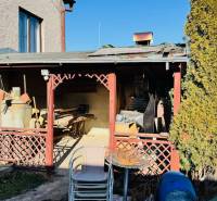 The exterior of a family house in Veľké Bielice in Partizánske with older stored tools.