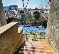 Colorful stairs leading from a family house in Veľké Bielice, Partizánske, into a snowy garden.