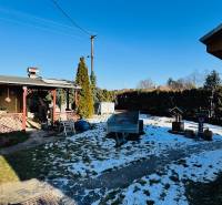 The garden of a family house in Veľké Bielice, Partizánske with a shelter and a snow-covered lawn.