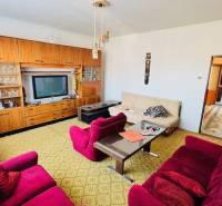 Living room in a family house with retro furniture and colorful armchairs.