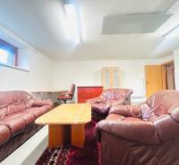 Leather sofa set with a coffee table, carpet, and work corner in a family house.