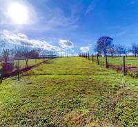 Sunny plot in Lieskovec for a family house with fencing and trees on a flat surface.