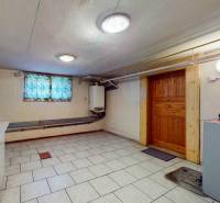 Basement in a family house with white tiles on the floor.