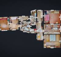 Floor plan of a family house with multiple rooms, a kitchen, and bathrooms, flooring with a wooden decor.