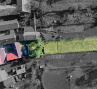 Aerial view of a family house in Lieskovec with a large yard and surrounding buildings.