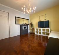 A living room with a wood-patterned floor in a 5 or more room apartment.