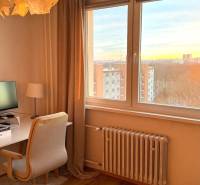 A workspace with a desk, chair, and view in a 3-room apartment.