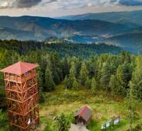 Observation tower on recreational grounds in Litmanová surrounded by dense forests and mountains.