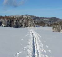 Recreational lands near Litmanová covered with snow, surrounded by snowy trees and hills.