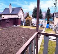 A yard with a house and garden in Partizánske, view from the balcony of the Cottage.