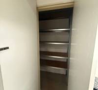 Pantry with shelves inside a 3-room apartment, suitable for storage.