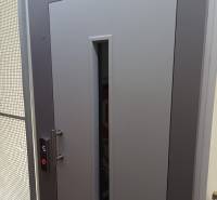 Gray door with a glass peephole and an elevator button, photo in a studio apartment.
