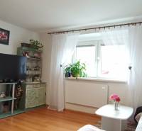 Living room in a family house with wooden floor decor and floral decorations.