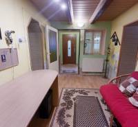 Interior of a family house with a wooden decor floor, comfortable sofa, and decorations.