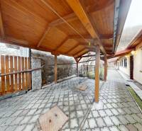 A double-sided terrace of a family house on Hlavná Street in Hronský Beňadik with a wooden shelter.