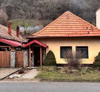 A family house on Hlavná Street in Hronský Beňadik with a red roof and a garden.