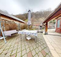 The porch of a family house on Hlavná Street in Hronský Beňadik with a swing and a table.