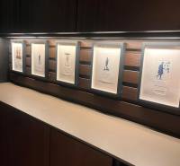 Framed pictures on a wooden shelf wall in a two-room apartment.