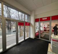 Interior of commercial premises with a view of the street through glass doors.