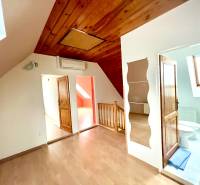 Interior of a family house with a wooden decor floor and a skylight.