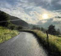 A road in agricultural and forest lands in Malachovo at sunrise.