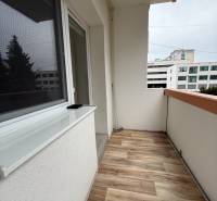 A balcony with a wooden decor floor in a studio apartment on Záborského Street in Martin.