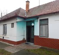 A family house in Kravany nad Dunajom with a brick roof and a paved entrance.