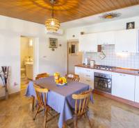 Kitchen in a recreational apartment with wood-decor flooring and a dining area.