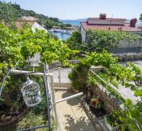 A holiday apartment on the island of Čiovo with a view of the sea and green surroundings.