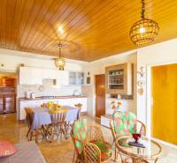 Recreational apartment with a kitchen, dining table, and wooden decor flooring.