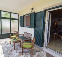 Terrace of a recreational apartment in Čiovo with comfortable seating and a view of the interior.