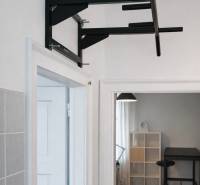 A shelf on the wall, with a room in the background featuring a wooden decor floor.