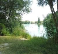 Nature by the water in Bratislava - Ružinov, Studená chata, surrounded by trees and greenery.