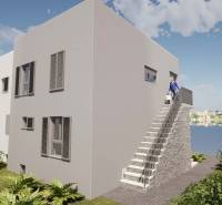 The exterior of a holiday apartment in Čiovo with a view of the sea and the surrounding landscape.