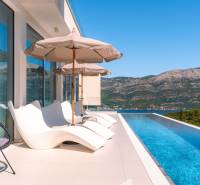 Villa in the town of Korčula with a pool, sunbeds, and mountain views.