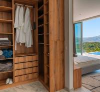 Wardrobe in a villa with a sea view, wooden decor flooring, swimming pool.